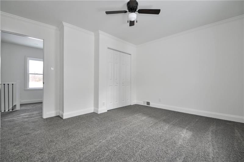 61 Bethel Ridge Road Avella, PA 15312 - Photo 23 of 28 an empty room with a ceiling fan and window