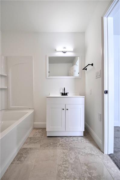61 Bethel Ridge Road Avella, PA 15312 - Photo 26 of 28 a bathroom with a bathtub sink and mirror