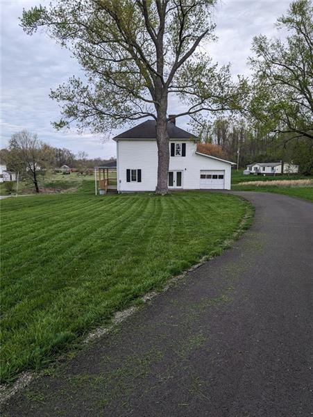 61 Bethel Ridge Road Avella, PA 15312 - Photo 4 of 28 a front view of a house with a yard and garage