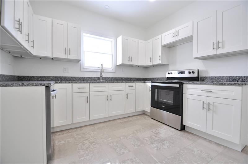 61 Bethel Ridge Road Avella, PA 15312 - Photo 9 of 28 a kitchen with granite countertop white cabinets white stainless steel appliances and sink
