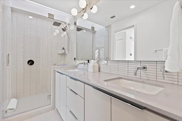 a bathroom with double sink and a mirror