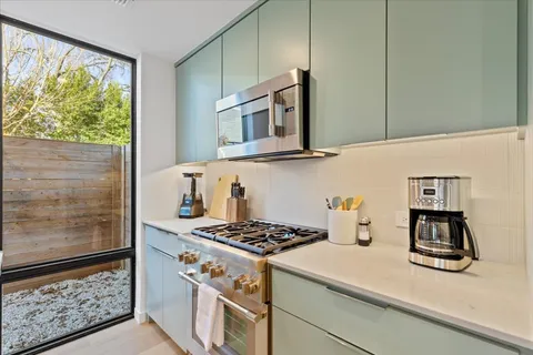 a kitchen with stainless steel appliances a stove and a refrigerator