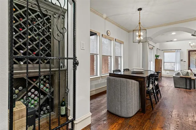 a kitchen with a refrigerator and a wooden floor
