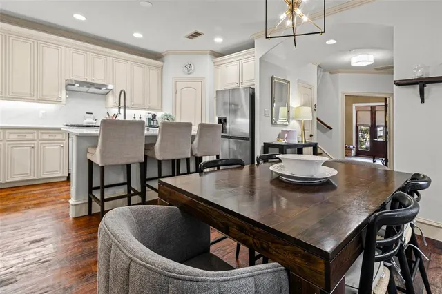 a kitchen with a table chairs stove and microwave