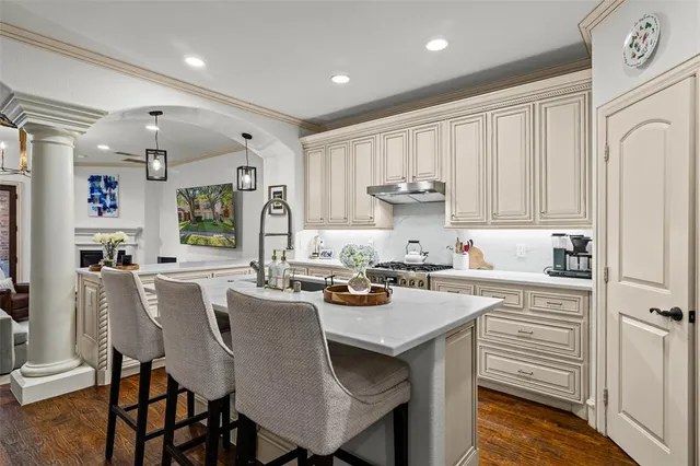 a kitchen with white cabinets stove and refrigerator