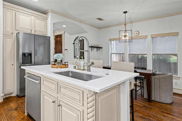 a kitchen with a sink a counter space and stainless steel appliances