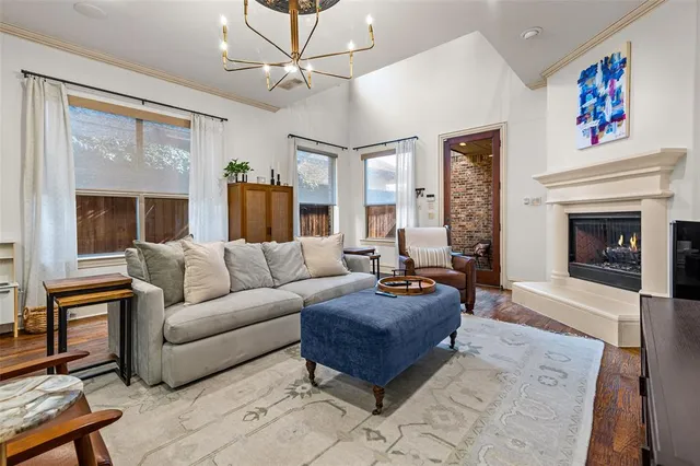 a living room with furniture a fireplace and a ceiling fan
