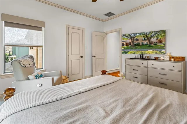 a bedroom with a bed and a flat screen television