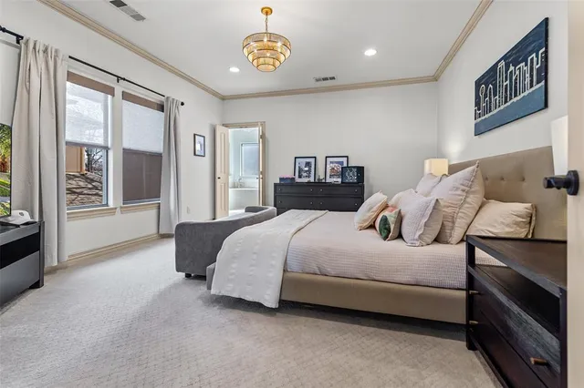 a spacious bedroom with a bed and a flat screen television