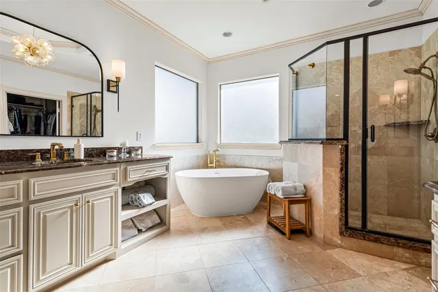 a en suite bathroom with a granite countertop sink and a mirror