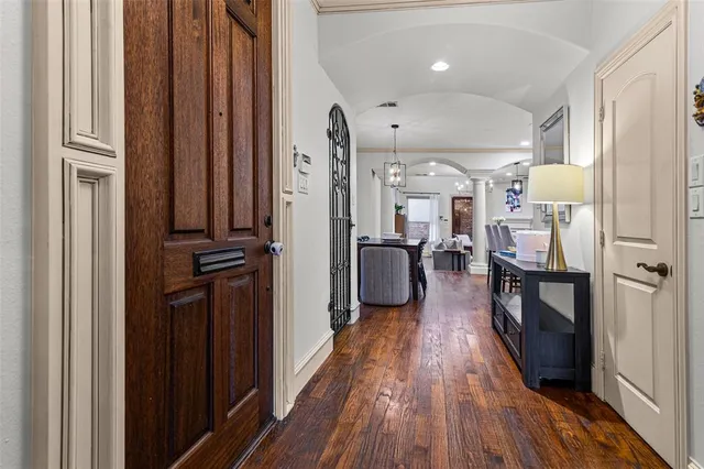 a view of a hallway with wooden floor and furniture