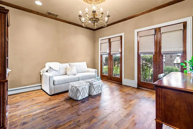 a living room with furniture and a chandelier