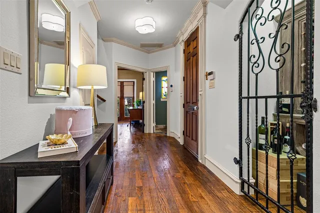 a view of a hallway with wooden floor and furniture
