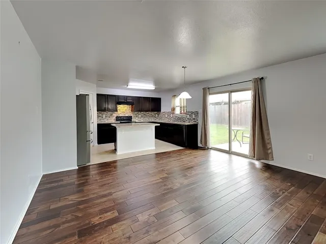 a view of a kitchen with a sink and a stove top oven