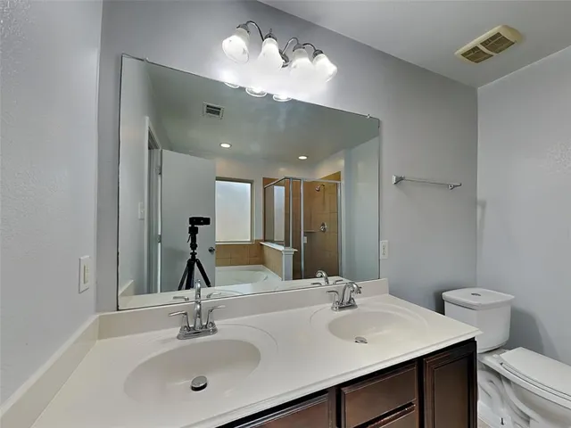 a bathroom with a sink vanity and a mirror