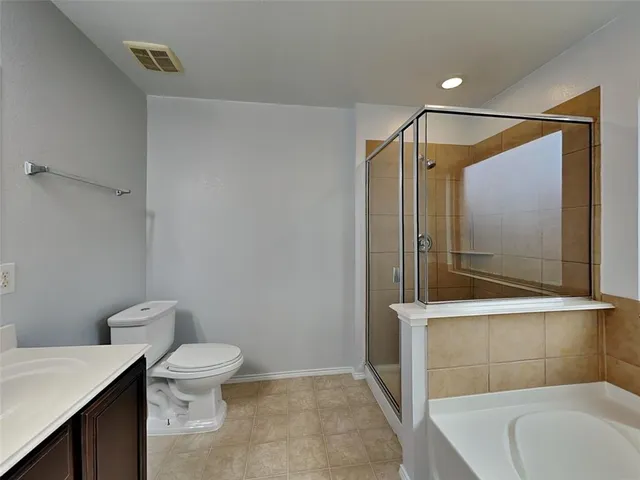 a bathroom with a toilet a sink and shower