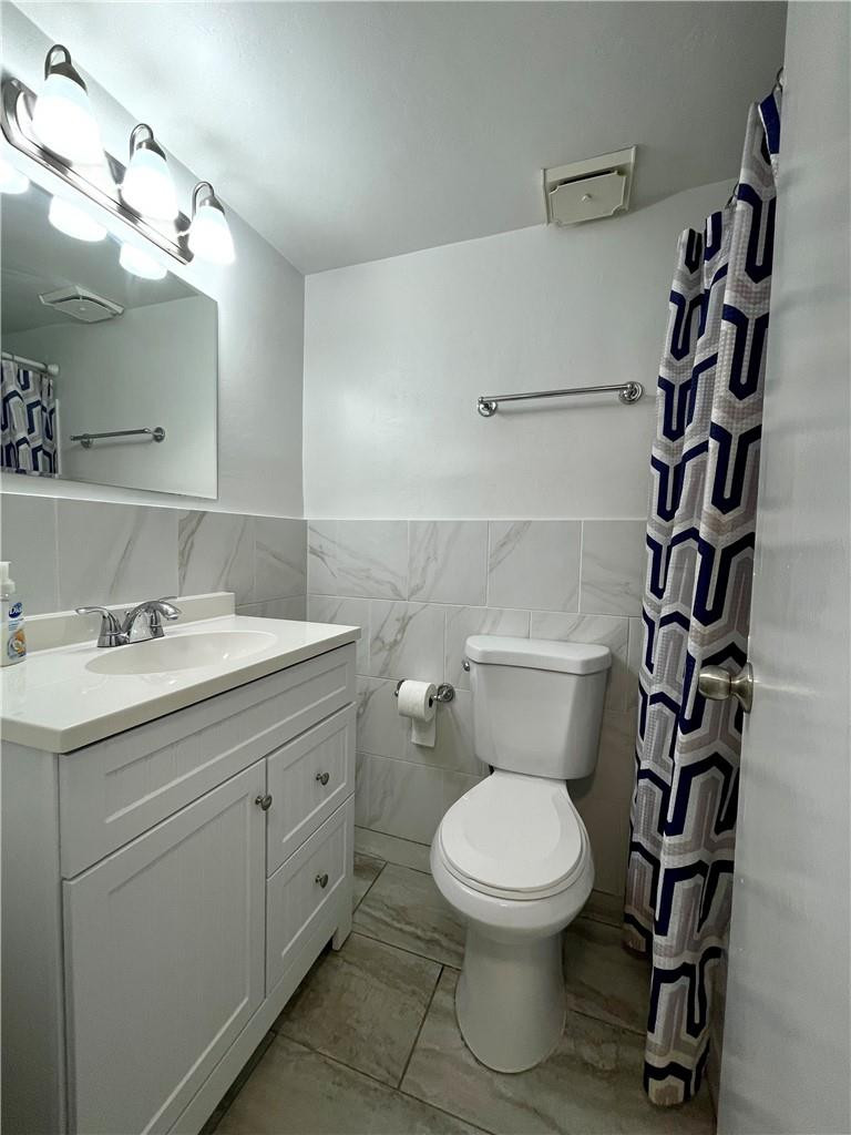 1990 West 56th Street, Unit 1205 Hialeah, FL 33012 - Photo 12 of 16 a bathroom with a toilet sink and mirror