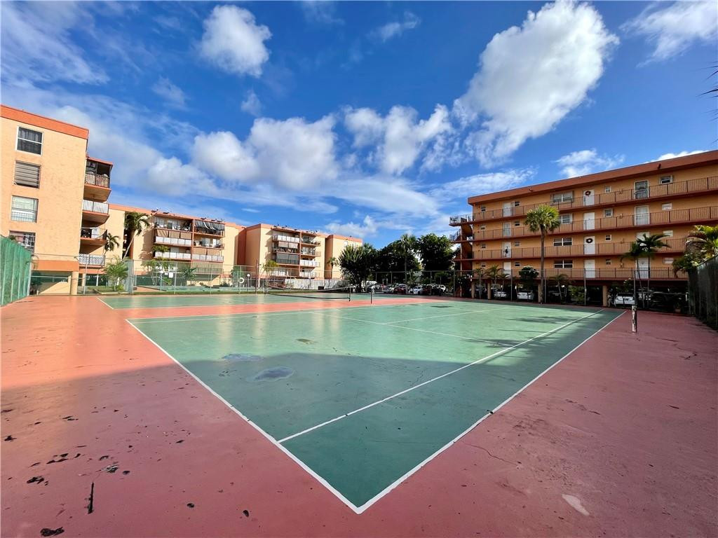 1990 West 56th Street, Unit 1205 Hialeah, FL 33012 - Photo 15 of 16 a view of a swimming pool with a yard