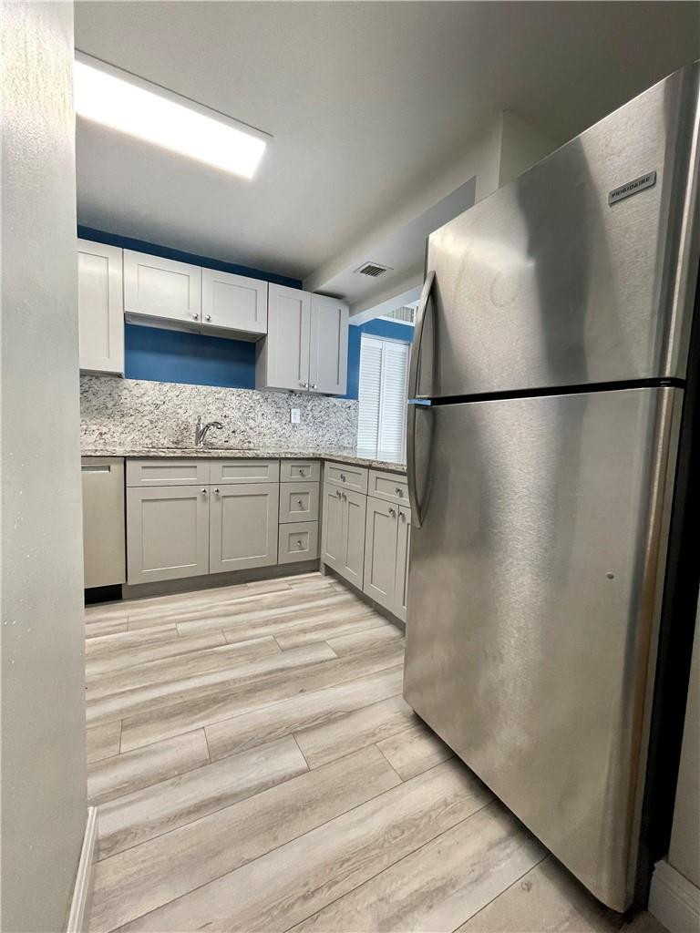 1990 West 56th Street, Unit 1205 Hialeah, FL 33012 - Photo 2 of 16 a kitchen with stainless steel appliances granite countertop a refrigerator and a sink