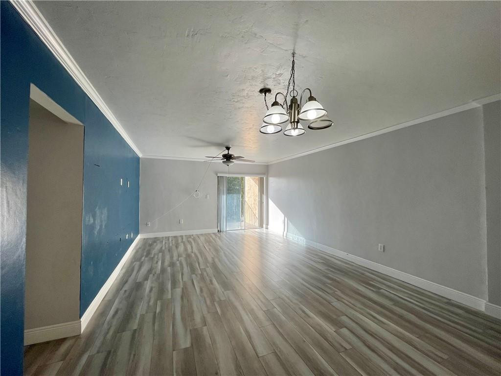 1990 West 56th Street, Unit 1205 Hialeah, FL 33012 - Photo 3 of 16 a view of livingroom with kitchen and wooden floor