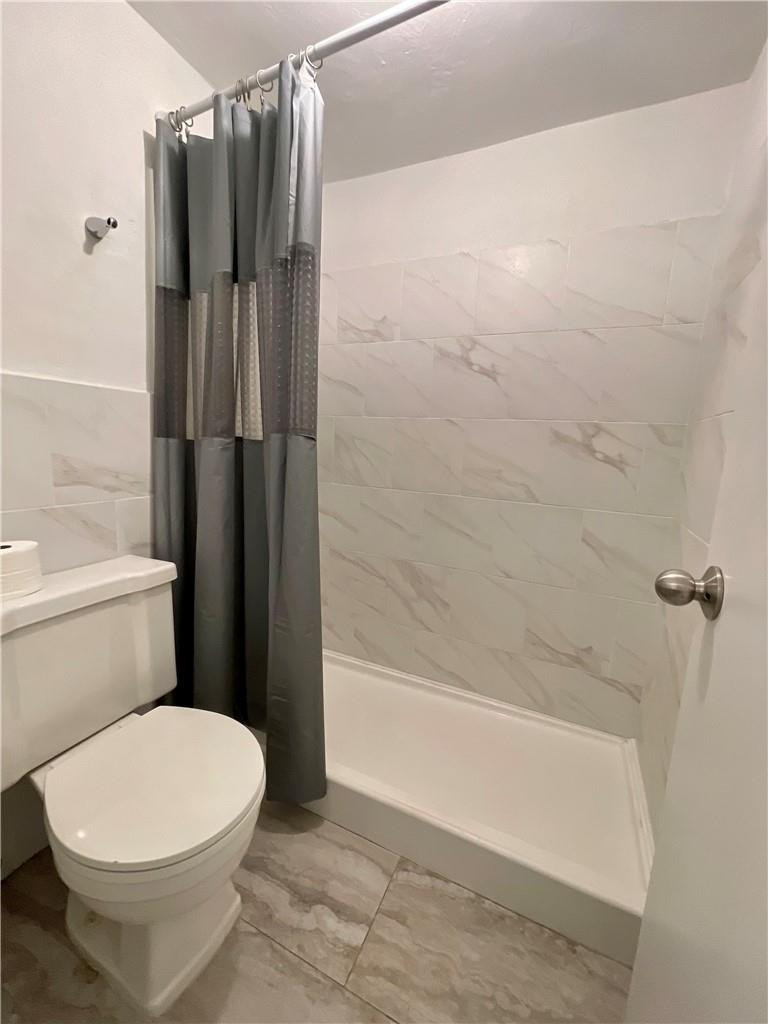 1990 West 56th Street, Unit 1205 Hialeah, FL 33012 - Photo 7 of 16 a bathroom with a toilet and shower