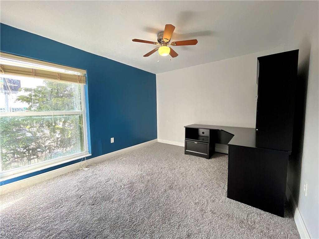 1990 West 56th Street, Unit 1205 Hialeah, FL 33012 - Photo 9 of 16 a view of an empty room with a window