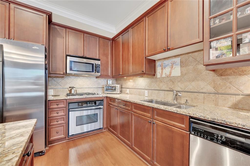 11 Perimeter Centre East, Unit 1112 Atlanta, GA 30346 - Photo 11 of 38 a kitchen with stainless steel appliances granite countertop a stove a sink and a refrigerator