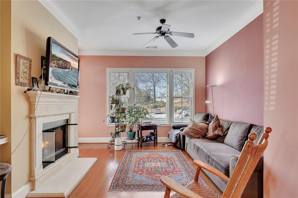 11 Perimeter Centre East, Unit 1112 Atlanta, GA 30346 - Photo 12 of 38 a living room with furniture a fireplace and a flat screen tv
