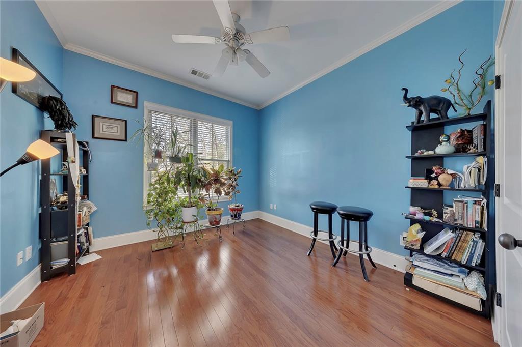 11 Perimeter Centre East, Unit 1112 Atlanta, GA 30346 - Photo 21 of 38 a furnished livingroom with a bookshelf and a window