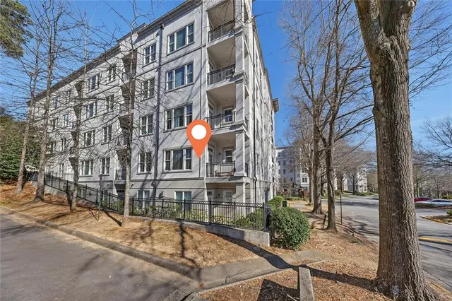 a view of a building with a backyard