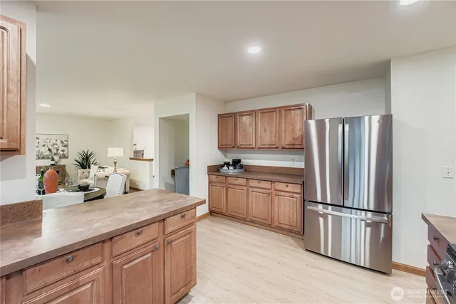 a kitchen with stainless steel appliances granite countertop a refrigerator sink and stove