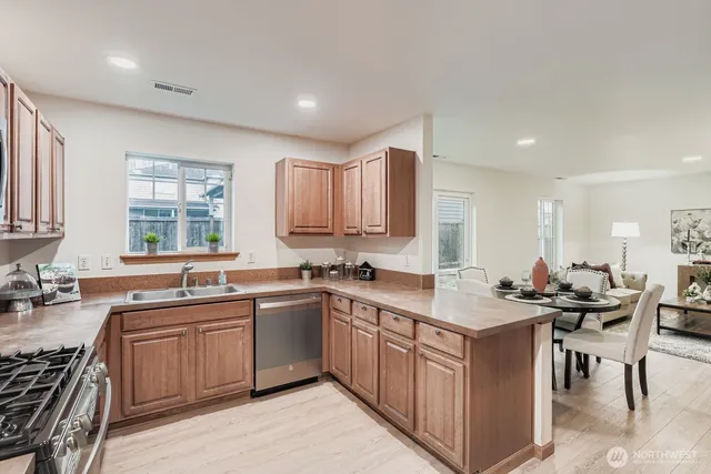 a kitchen with a sink stove and cabinets