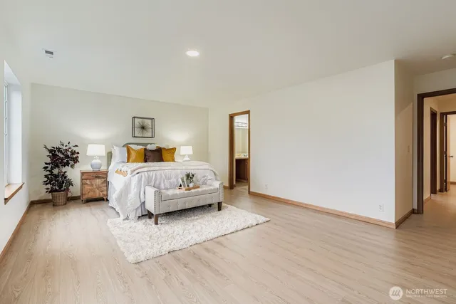 a bedroom with a bed and wooden floor