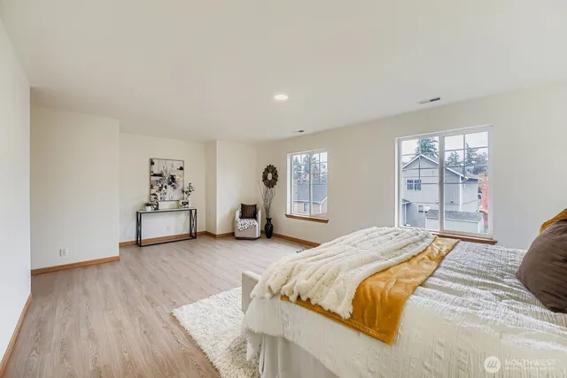 a spacious bedroom with a bed and a window