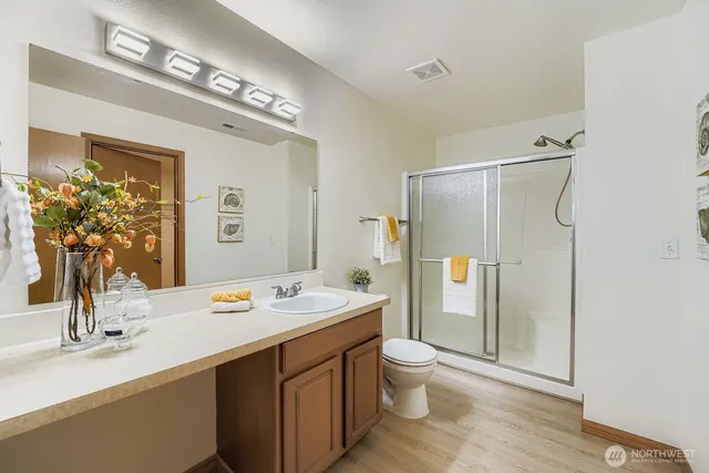 a bathroom with a sink toilet and shower