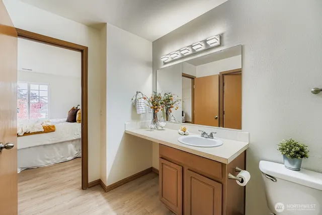 a bathroom with a sink a toilet and a mirror