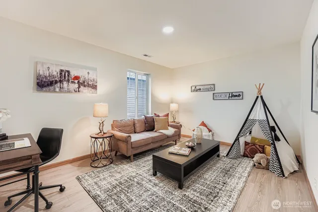 a living room with furniture and a wooden floor