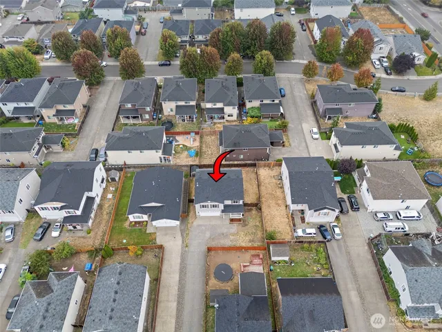 an aerial view of residential houses with outdoor space