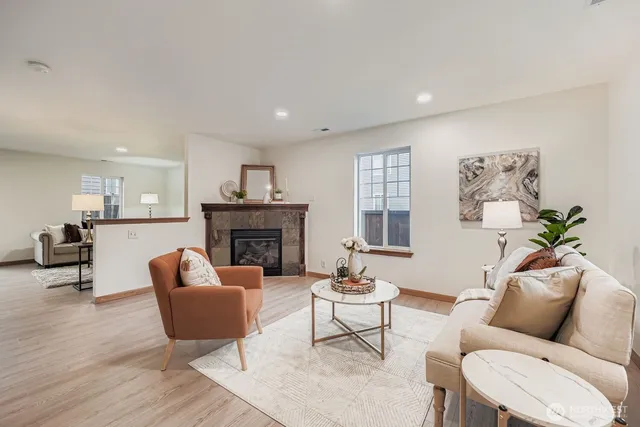 a living room with furniture a fireplace and a table