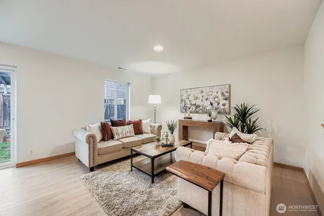 a living room with furniture and a potted plant
