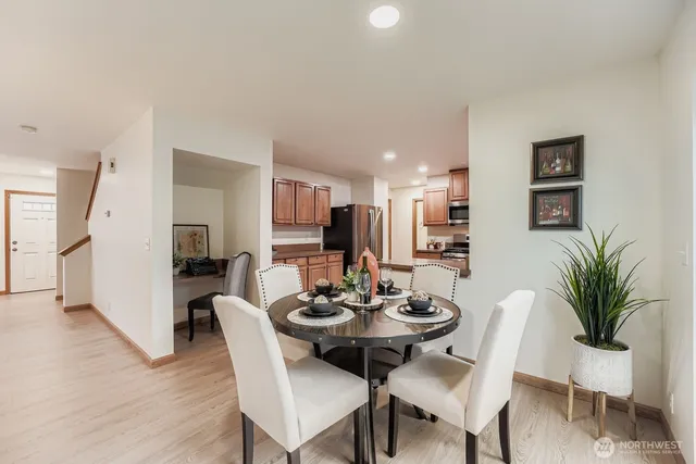 a view of a dining room with furniture and wooden floor