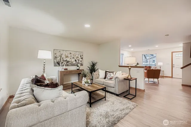 a living room with furniture and wooden floor