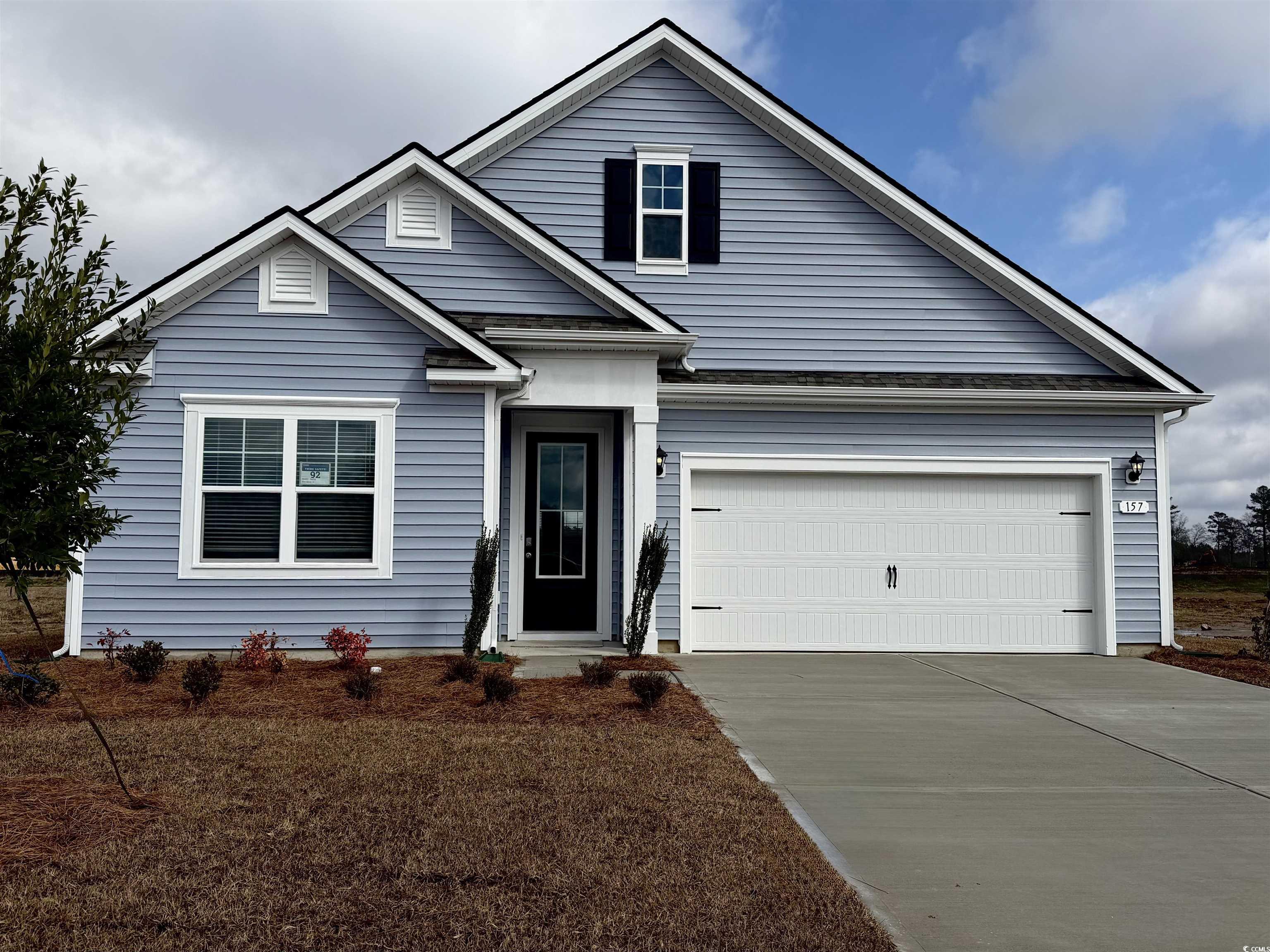 Traditional-style home with driveway and a front lawn