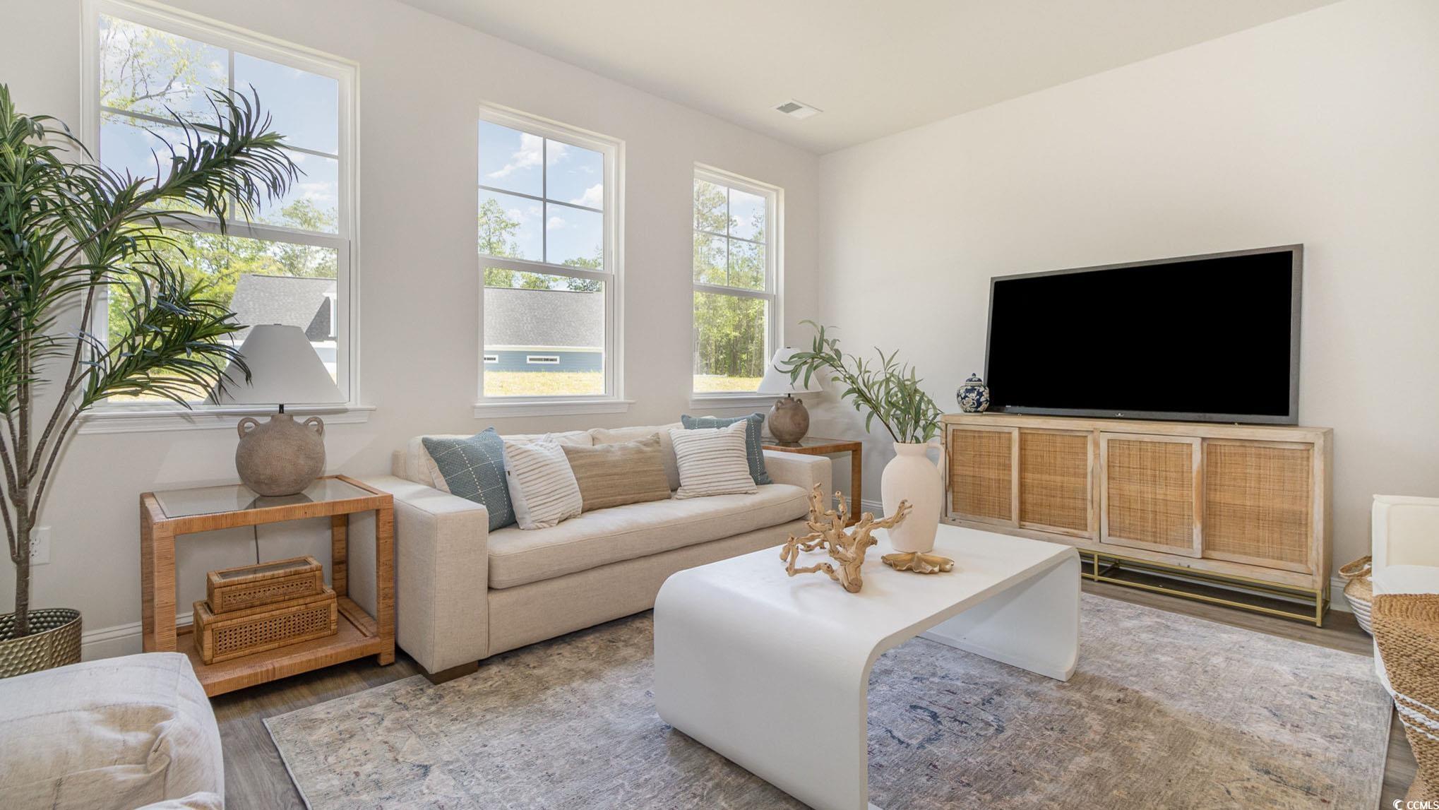 157 Bjorn Way Loris, SC 29569 - Photo 12 of 34 Living area featuring wood finished floors and baseboards