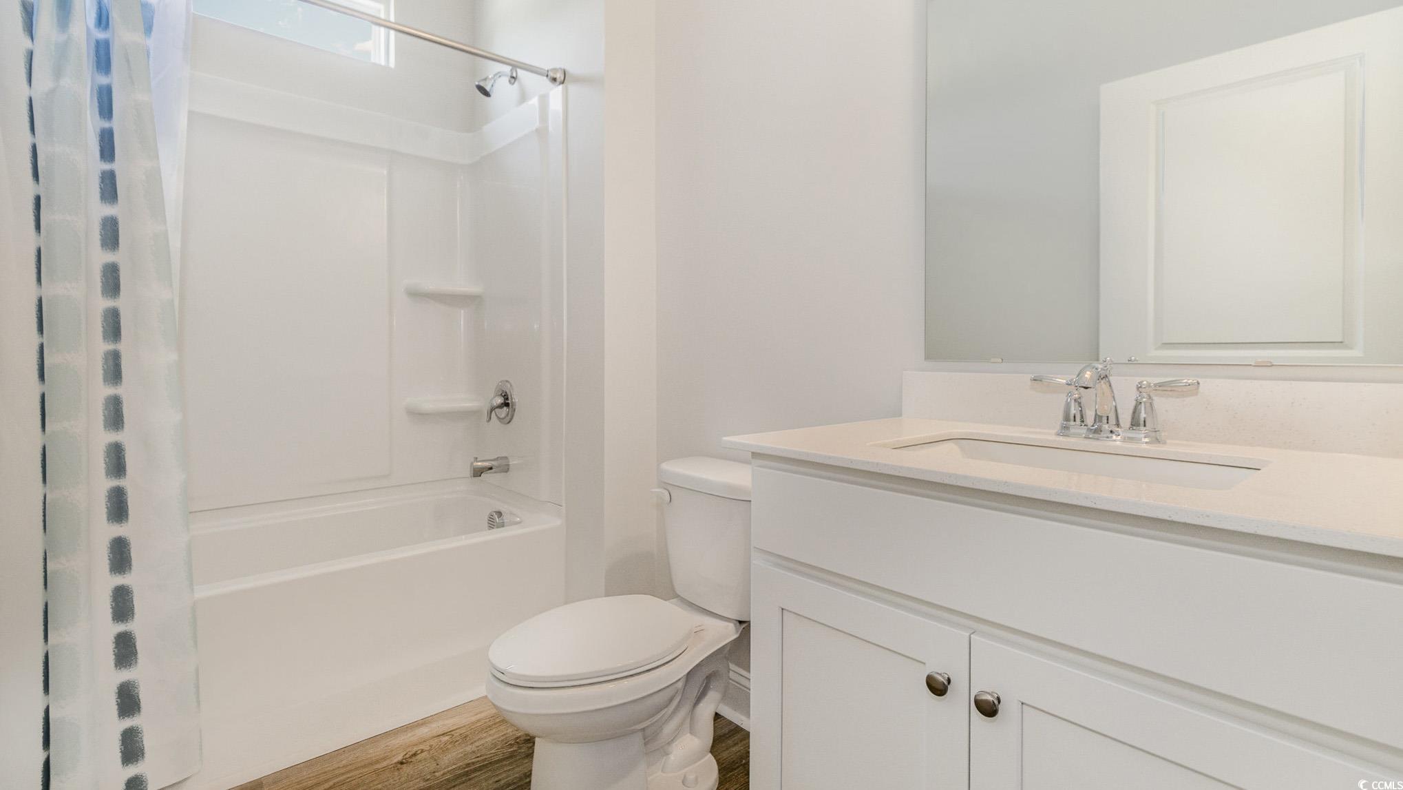 157 Bjorn Way Loris, SC 29569 - Photo 18 of 34 Full bathroom featuring shower / bath combination with curtain, vanity, and wood finished floors