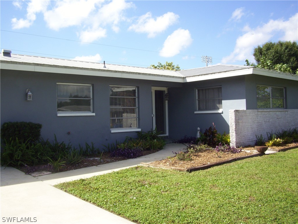 1448 Charles Road Fort Myers, FL 33919 - Photo 2 of 26 a front view of a house with garden