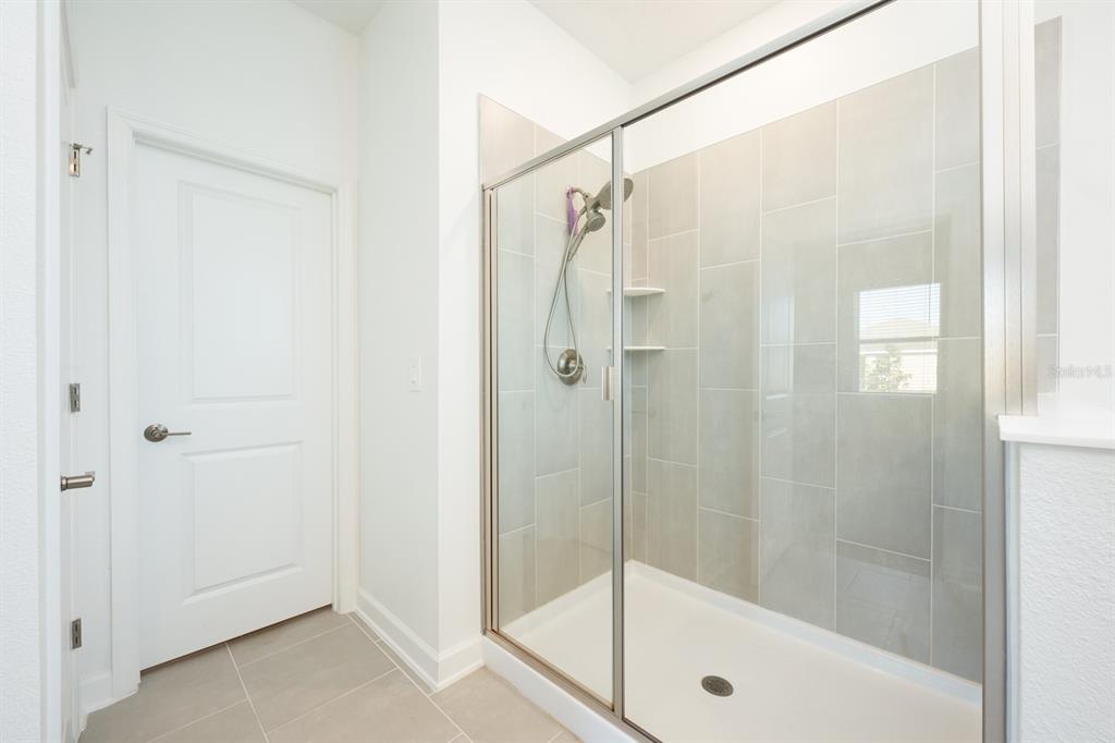 1874 Flourish Avenue Kissimmee, FL 34744 - Photo 12 of 35 a bathroom with a shower