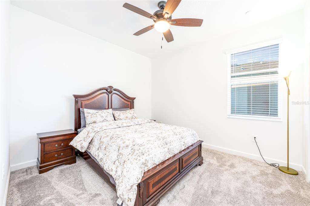 1874 Flourish Avenue Kissimmee, FL 34744 - Photo 14 of 35 a bedroom with a bed and a window