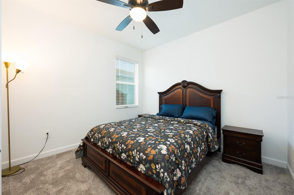 1874 Flourish Avenue Kissimmee, FL 34744 - Photo 17 of 35 a bedroom with a bed and window