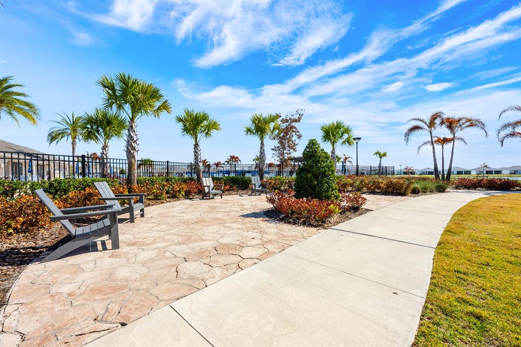 1874 Flourish Avenue Kissimmee, FL 34744 - Photo 28 of 35 a view of a swimming pool with a lounge chair and palm trees
